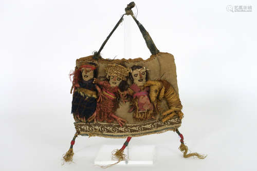 Peruvian Chancay Culture tomb find in textile with the representation of three dolls (figures) and a dog