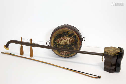 a Chinese drum (in painted leather) and a musical string instrument