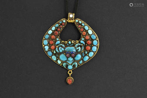 Tibetan “Ccheppu” sharm/pendant in yellow gold (20/22 carat) with red coral, turquoise, ruby and a small pearl