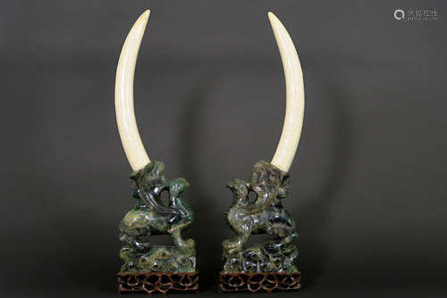 pair of Chinese griffin sculptures in quartz, each with a tusk