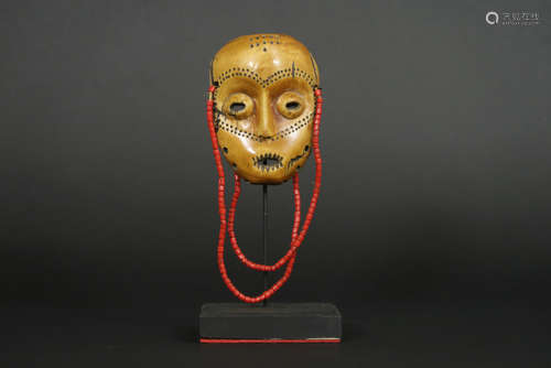 African Congolese ‘Lega’ sharm in the shape of a mask in ivory with the typical Lega characteristics