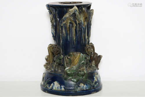 antique Chinese pedestal in glazed earthenware with (beheaded) figures and plants