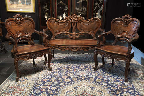 antique Chinese salonsuite in an exotic wood species with finely carved ornamentation