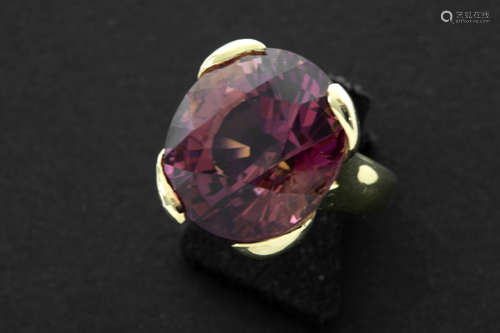 quite exceptional tourmaline of ca 22 carat with a rare reddish pink color, set in a handmade ring in yellow gold (18 carat)