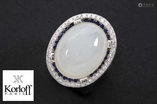 ”Korloff” ring in white gold (18 carat) with a ca 18 carat cabochon moonstone (cat’s eye) surrounded by ca 8 carat of sapphires and ca 1 carat of very high quality brilliant cut diamonds – signed