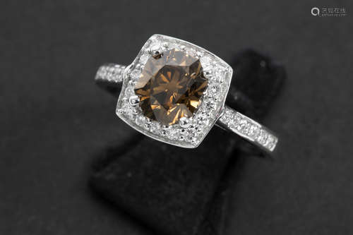 ring in white gold (18 carat) with a 1,77 carat fancy cognac color and ca 0,70 carat of small white quality brilliant cut diamonds