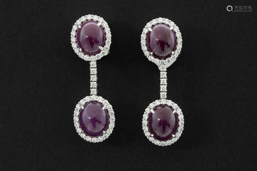 matching pair of earrings in white gold (18 carat) with at least 24 carat of ruby (cabochon cut) and ca 2,50 carat of very high quality brilliant cut diamonds