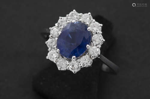 ring in white gold (18 carat) with a central ca 1,80 carat oval sapphire surrounded by ca 0,50 carat brilliant cut diamonds