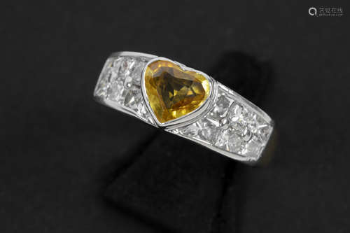 ring in yellow and white gold (18 carat) with a 1,70 carat heartshaped yellow sapphire from Ceylan and ca 2 carat of high quality princess’ cut diamonds