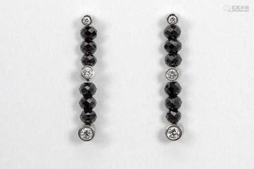 pair of earrings in white gold (18 carat) with ca 2,50 carat of black diamonds and at least 0,20 carat of bluewhite high quality brilliant cut diamonds