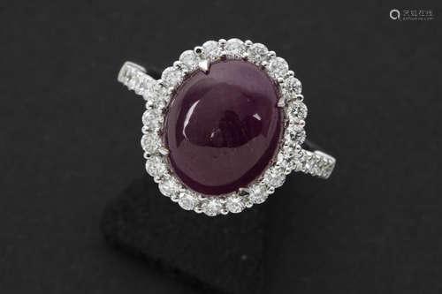 matching ring in white gold with a cabochon cut ruby ot at least 6 carat, surrounded by ca 0,90 carat of very high quality brilliant cut diamonds