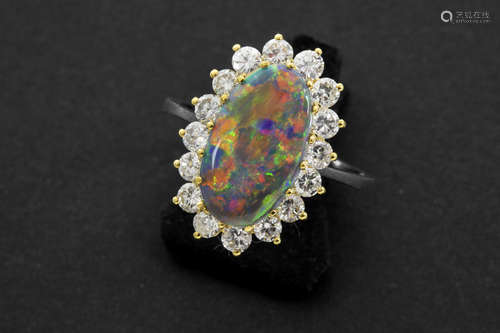 ring in yellow and white gold (18 carat) with a rare real black opal of 2,95 carat surrounded by ca 1,30 carat of very high quality brilliant cut diamonds