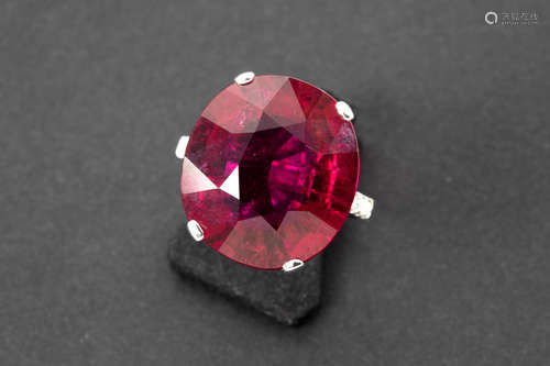 important and rare, oval rubelite tourmaline of ca 19 carat and with a very nice color, set in a ring in white gold (18 carat) with at least 0,20 carat of high quality brilliant cut diamonds