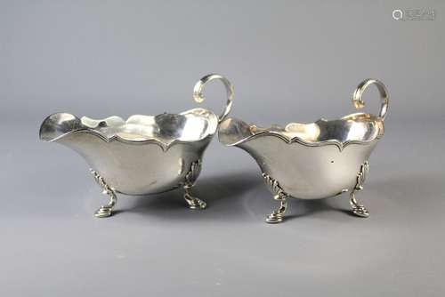 A Pair of Antique French Silver Sauce Boats, approx 503 gms, with scallop rim, raised on hoof feet, bearing Parisian hallmarks