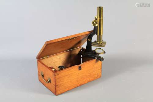 A Victorian Moritz Pillischer London Monocular Microscope Brass Microscope. The microscope with brass barrel, brass wheels, concave mirror and horseshoe base, approx 27 cms, contained within a mahogany box.