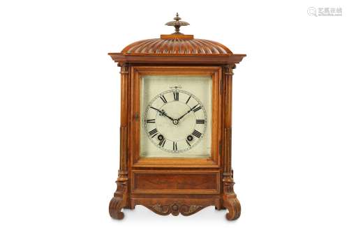A LATE 19TH CENTURY WALNUT MANTEL CLOCK the case with dome and gadrooned top with brass finial over,