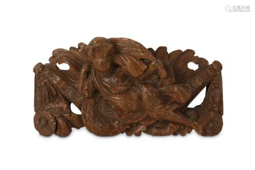 A 17TH CENTURY CARVED OAK RELIEF DEPICTING A PUTTO  the reclining putto riding on what appears to be