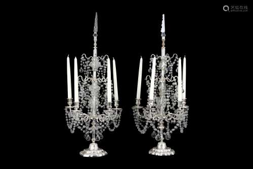 A PAIR OF REGENCY STYLE SILVERED BRASS AND GLASS LUSTRE CANDELABRA raised on dome feet, one with