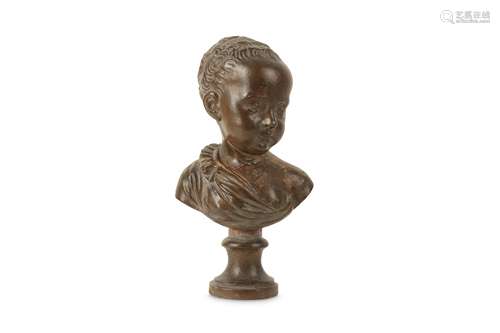 AN 18TH CENTURY FRENCH PATINATED TERRACOTTA BUST OF A YOUNG BOY IN THE MANNER OF JEAN-ANTOINE HOUDON