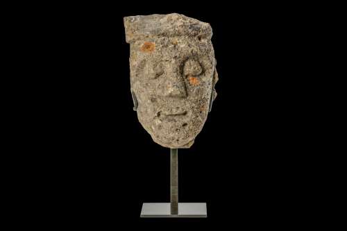 A 13TH CENTURY GOTHIC CARVED LIMESTONE HEAD an architectural fragment, now raised on a metal