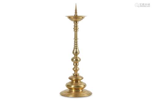 A LARGE LATE 17TH CENTURY GERMAN BRONZE PRICKET CANDLESTICK the dished top raised on the baluster,