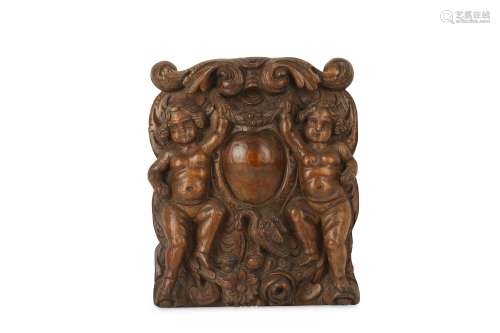 A 17TH CENTURY NORTH EUROPEAN CARVED WALNUT PANEL WITH A CARTOUCHE the relief carved panel with a