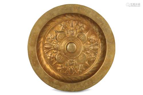 A 16TH CENTURY NUREMBERG REPOUSSE BRASS ALMS DISH OF BACCHIC THEME of typical bowl form, the outside