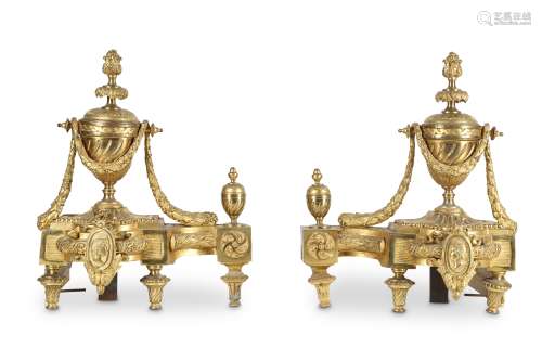 A PAIR OF LATE 19TH CENTURY FRENCH LOUIS XVI STYLE GILT BRONZE CHENETS modelled as swagged urns