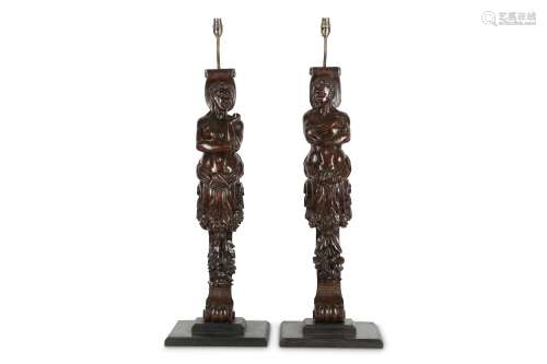 A PAIR OF 19TH CENTURY CARVED OAK CARYATID FIGURES LATER ADAPTED AS LAMP BASES in the 17th century