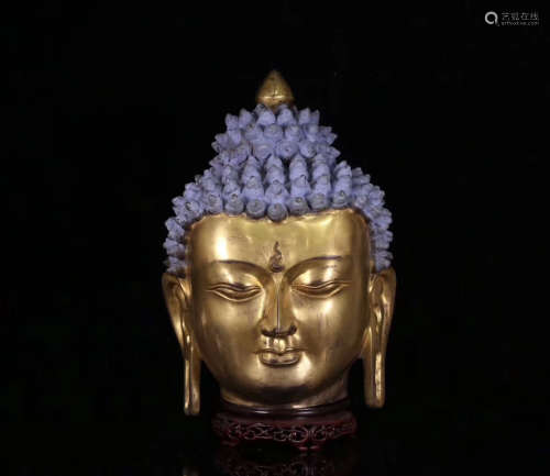 A GILT BRONZE MOLDED BUDDHA HEAD STATUE