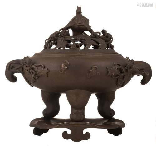 A Chinese patinated bronze open work tripod incense