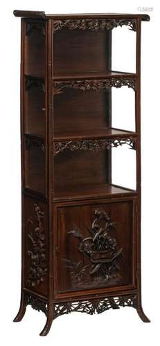 An Oriental richly carved hardwood display cabinet with