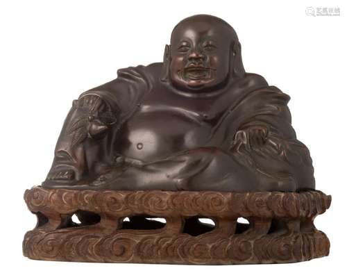 A Chinese bronze Budai on a matching carved wooden