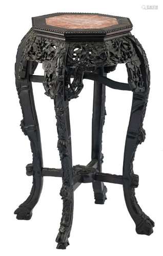 A Chinese carved wooden octagonal stand with marble