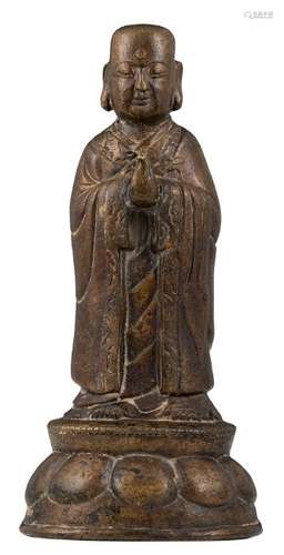 A Chinese patinated bronze figure depicting a Lohan