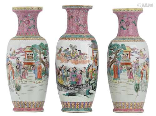 A pair of Chinese famille rose vases, decorated with