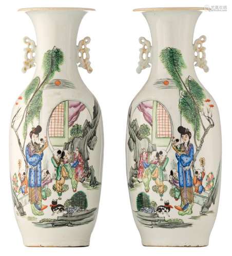 A pair of Chinese famille rose vases, decorated with a