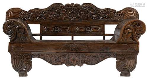 A Balinese carved hardwood bench, decorated with