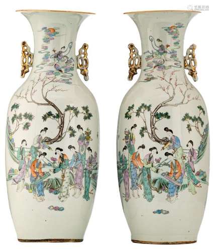 A pair of Chinese famille rose vases, decorated with a