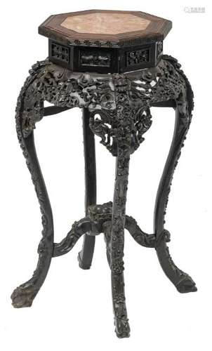 A Chinese richly carved hexagonal hardwood stool with