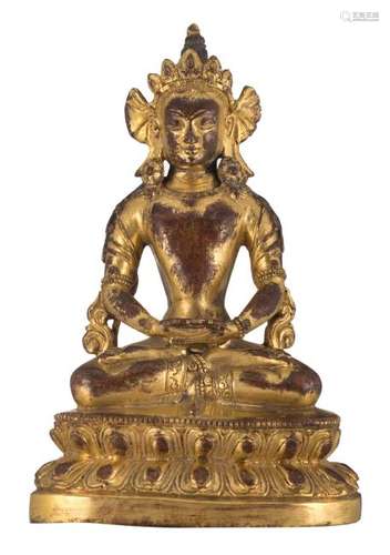 A Chinese gilt bronze seated Buddha on a lotus base, H