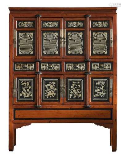 A Chinese carved wooden cabinet, the black lacquered