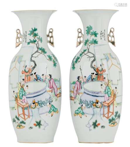 A pair of Chinese famille rose vases, decorated with