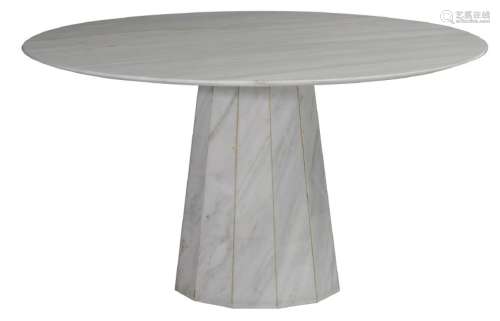 A wide round marble dining table on a central polygonal