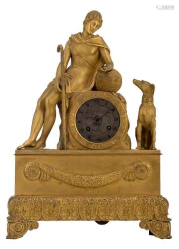 A gilt bronze mantel clock with on top a bucolic scene,