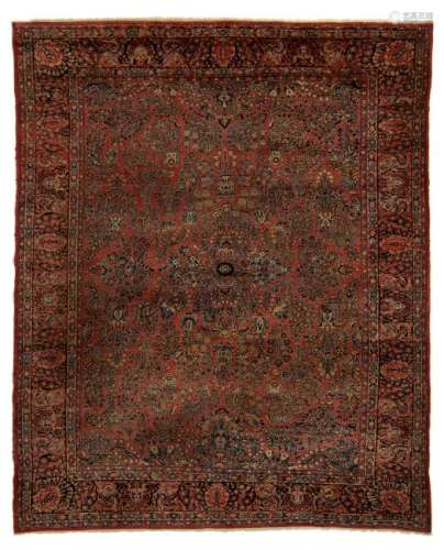 An Oriental rug, decorated with floral motifs, wool on
