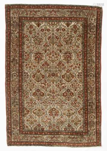 A fine Oriental silk rug, decorated with floral motifs