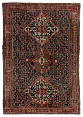An Oriental rug, decorated with stylised floral motifs,