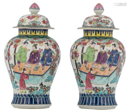 A pair of polychrome vases and covers, decorated with