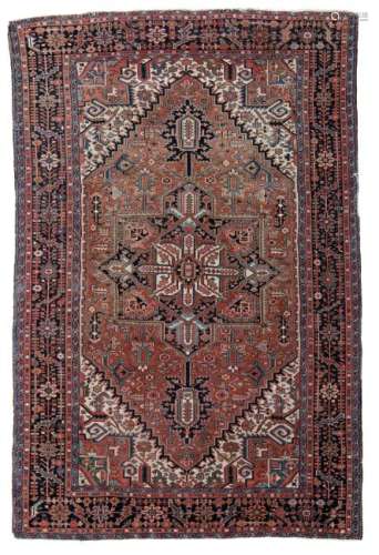 An Oriental rug with stylized floral motifs, wool on